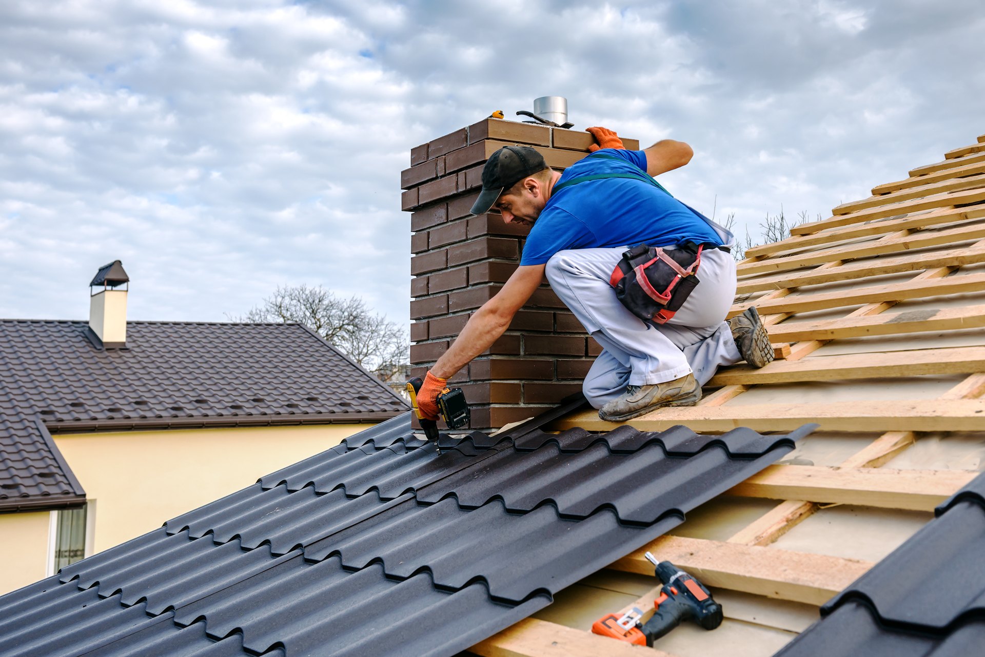 Ceramic roof tiles being installed